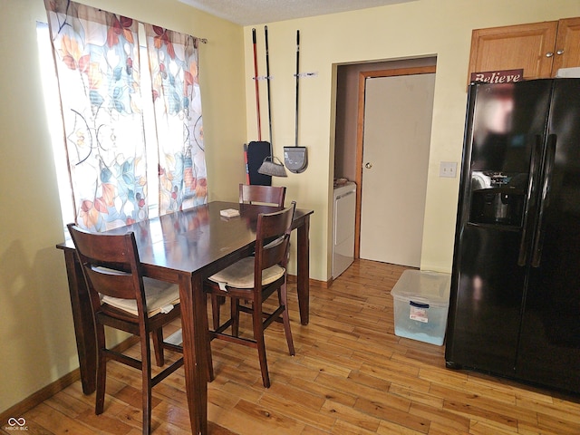 dining room featuring light wood finished floors and washer / clothes dryer