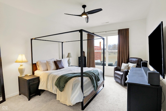 bedroom with a ceiling fan, light colored carpet, visible vents, and baseboards