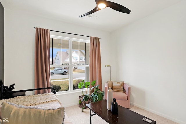 carpeted bedroom featuring visible vents, multiple windows, a ceiling fan, and baseboards