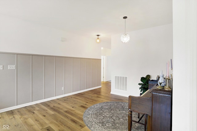 interior space with wood finished floors and visible vents