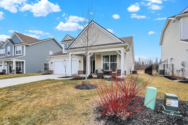 view of front of home featuring an attached garage, covered porch, concrete driveway, board and batten siding, and a front yard