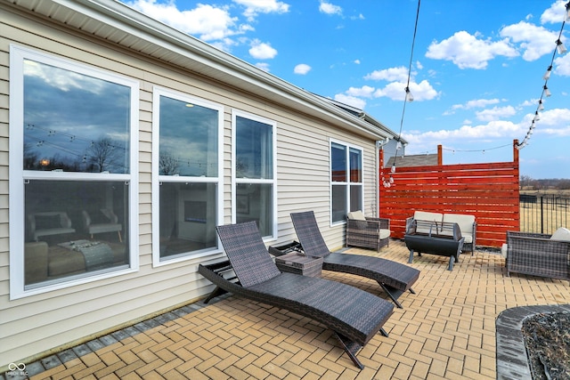 view of patio / terrace featuring fence and an outdoor hangout area