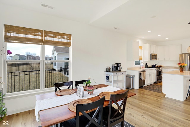 dining space featuring recessed lighting, visible vents, and light wood finished floors