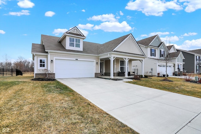 view of front of house featuring a garage, concrete driveway, covered porch, board and batten siding, and a front yard