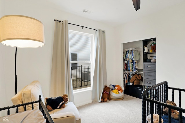 carpeted bedroom featuring a ceiling fan, visible vents, and a closet