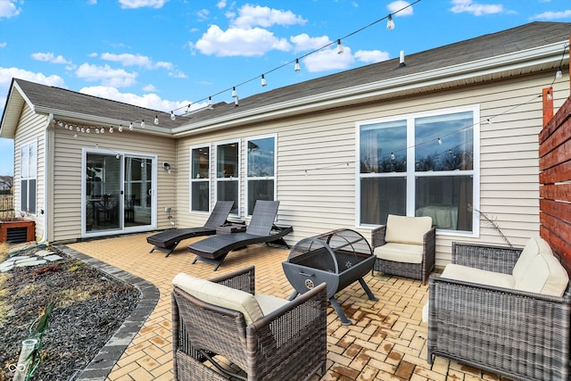 back of property featuring a patio and an outdoor living space