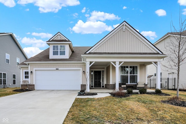 craftsman-style home with a porch, a garage, driveway, a front lawn, and board and batten siding