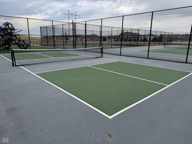 view of sport court featuring community basketball court and fence