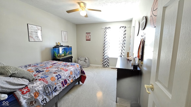 carpeted bedroom featuring ceiling fan and baseboards