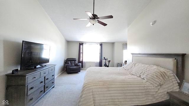 bedroom featuring light carpet, a textured ceiling, a ceiling fan, and baseboards