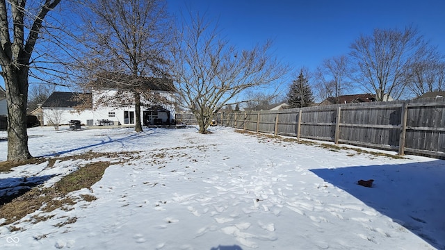 yard covered in snow featuring a fenced backyard