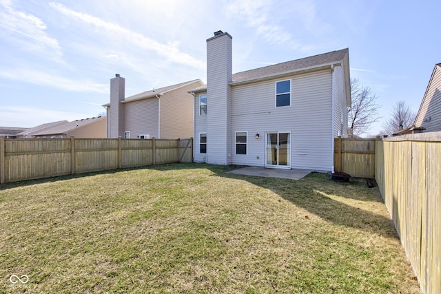 back of house with a patio, a lawn, and a fenced backyard