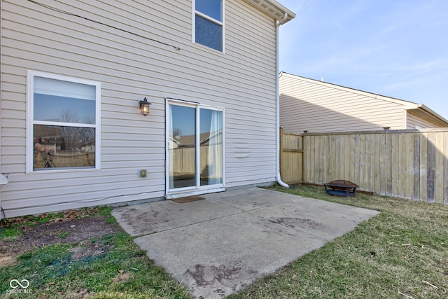 exterior space featuring a fire pit and fence