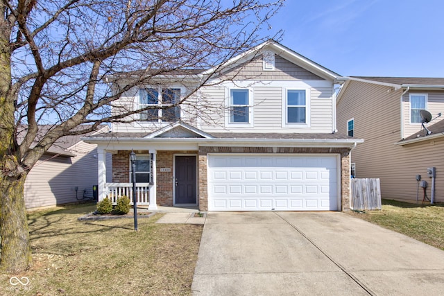 traditional-style home featuring a porch, concrete driveway, a front yard, an attached garage, and brick siding