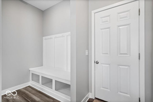 mudroom with dark wood-style flooring and baseboards