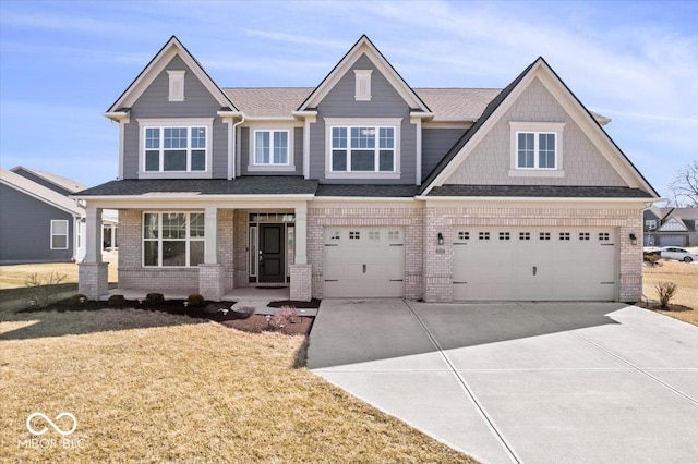 view of front of home featuring a garage, brick siding, concrete driveway, and a front yard