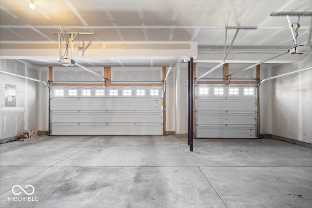 garage with electric panel and a garage door opener