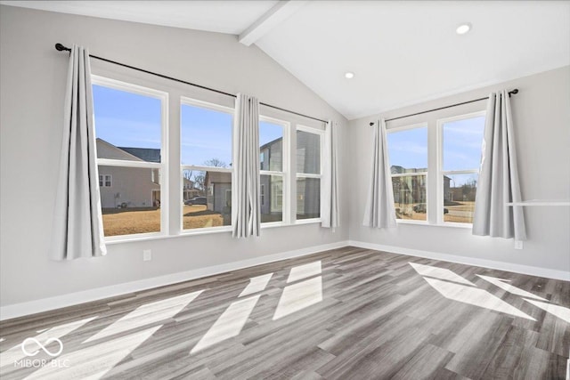 spare room with recessed lighting, vaulted ceiling with beams, baseboards, and wood finished floors