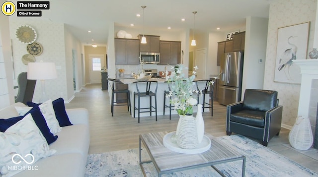 living room featuring wallpapered walls, baseboards, light wood finished floors, and recessed lighting