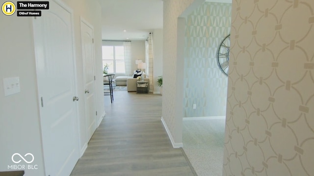 hall with light wood-type flooring, baseboards, and recessed lighting