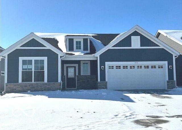 craftsman-style house featuring a garage and stone siding