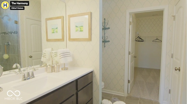 bathroom with tile patterned floors, vanity, and wallpapered walls