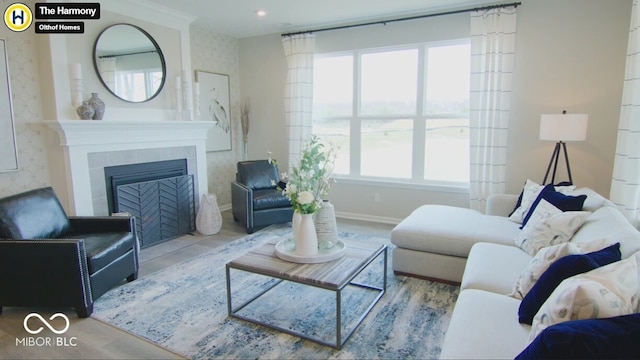 living room featuring recessed lighting, a fireplace, and baseboards