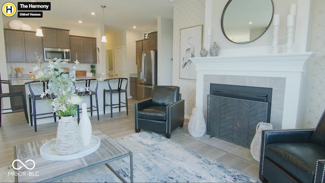 living room with a tiled fireplace and recessed lighting