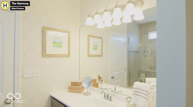 bathroom featuring wallpapered walls and vanity