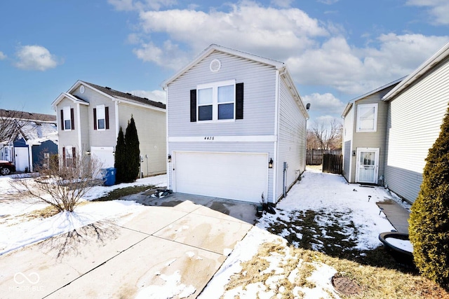 traditional home featuring an attached garage and concrete driveway