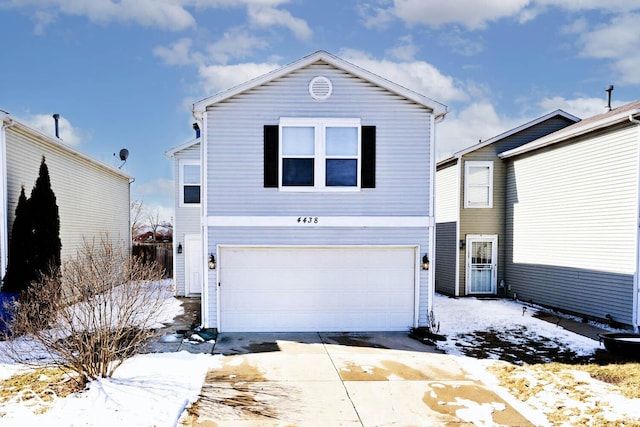 traditional-style house featuring a garage and concrete driveway