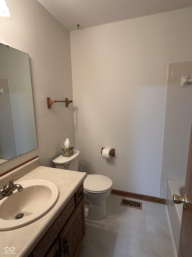 full bath with baseboards, toilet, tile patterned floors, a textured ceiling, and vanity