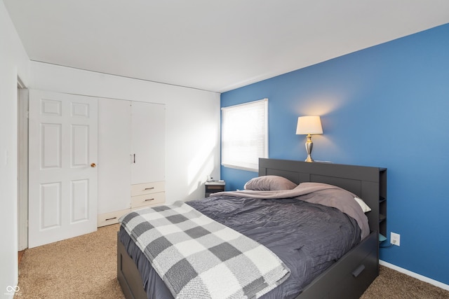 bedroom featuring carpet, baseboards, and a closet