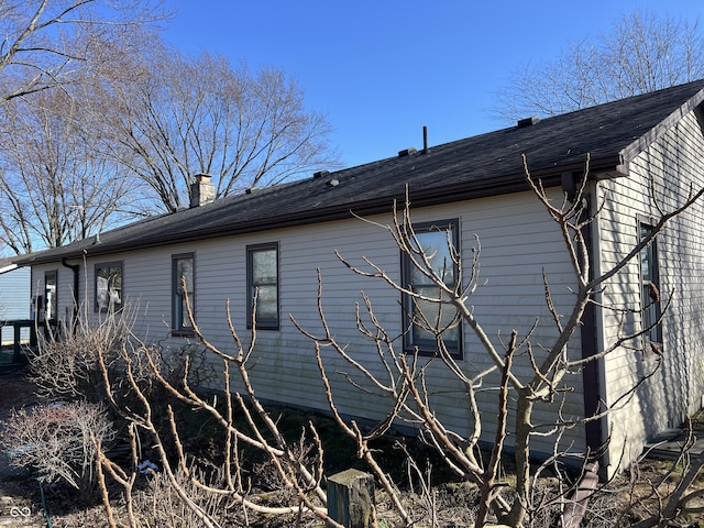 view of side of home featuring a chimney