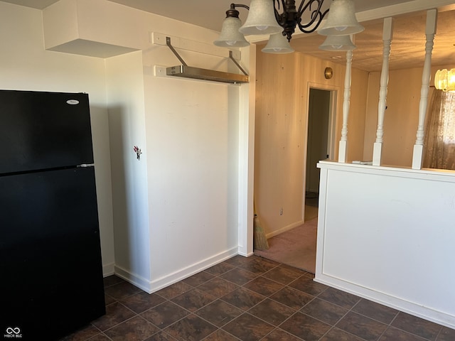 kitchen with an inviting chandelier, baseboards, and freestanding refrigerator