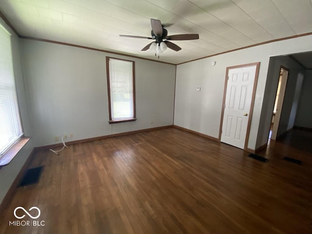 unfurnished bedroom with dark wood-style floors, ornamental molding, and visible vents