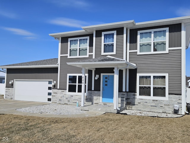 view of front of home featuring a garage, stone siding, driveway, and a front lawn