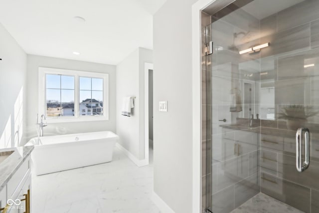 bathroom with a stall shower, baseboards, marble finish floor, a freestanding bath, and vanity