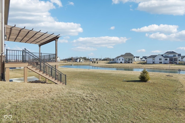 view of yard featuring stairway, a water view, a residential view, and a pergola