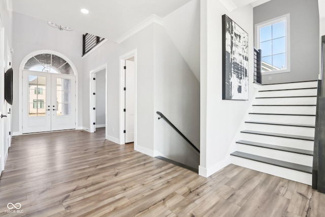 entrance foyer featuring light wood-style floors, recessed lighting, baseboards, and french doors