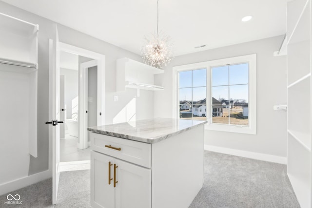 spacious closet featuring a chandelier, visible vents, and light colored carpet