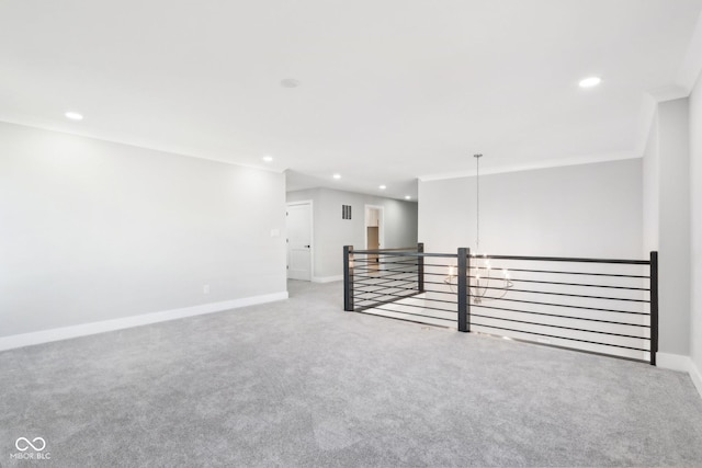 empty room with light carpet, baseboards, crown molding, and recessed lighting