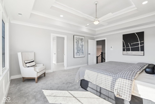 bedroom with ornamental molding, a raised ceiling, light carpet, and baseboards