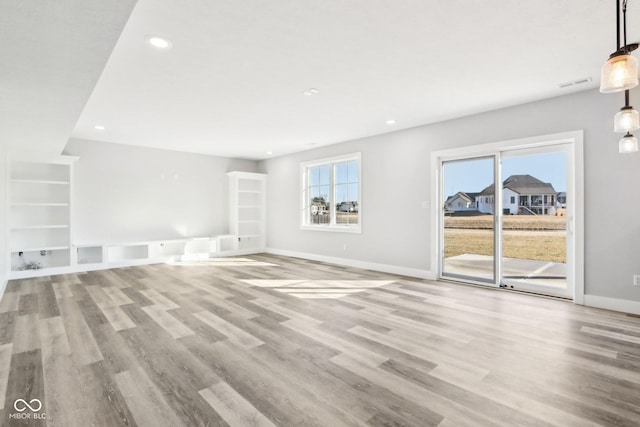 unfurnished living room with recessed lighting, visible vents, light wood-style flooring, and baseboards