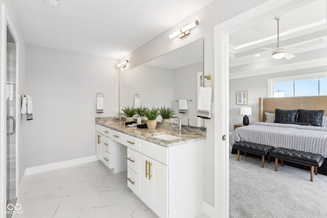 ensuite bathroom featuring ceiling fan, a sink, baseboards, marble finish floor, and double vanity