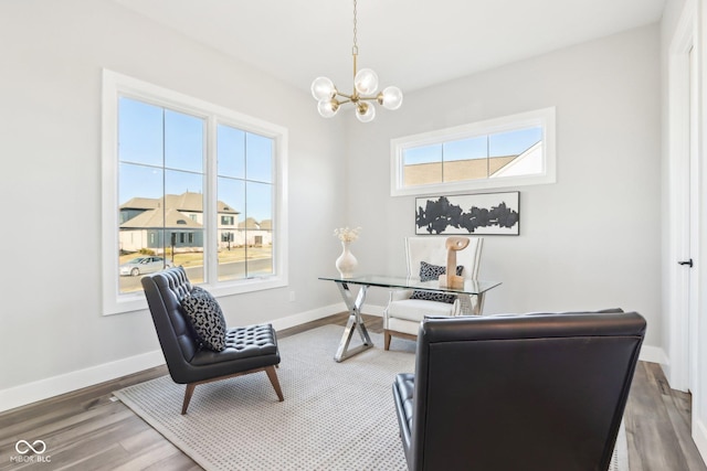 office area with a chandelier, baseboards, and wood finished floors