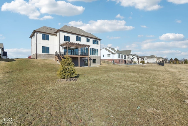 rear view of property with a yard, a residential view, and a pergola