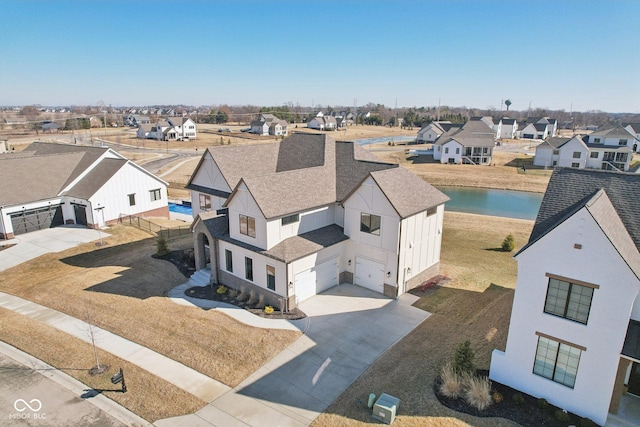 drone / aerial view featuring a water view and a residential view