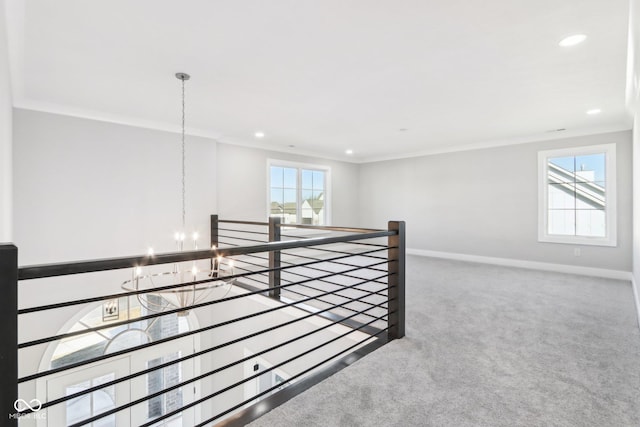 corridor with an inviting chandelier, carpet, an upstairs landing, and baseboards