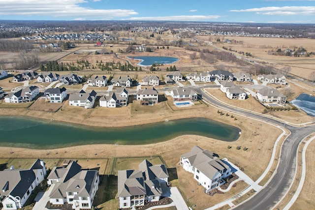 birds eye view of property featuring a water view and a residential view